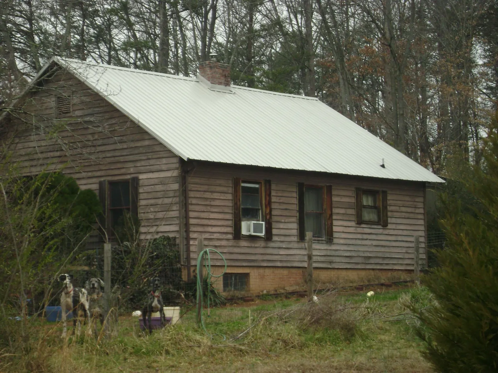 White metal roof on an old wood sided farmhouse, from a Metal Roof Installation job in La Grange